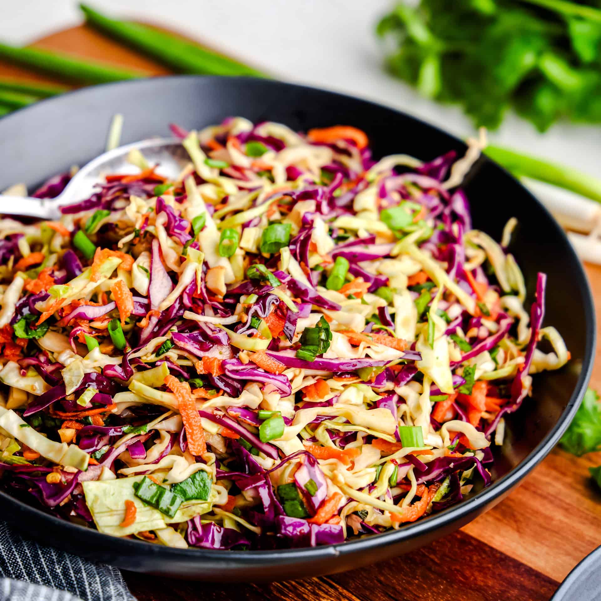 Spicy Sesame Coleslaw in a black serving bowl.