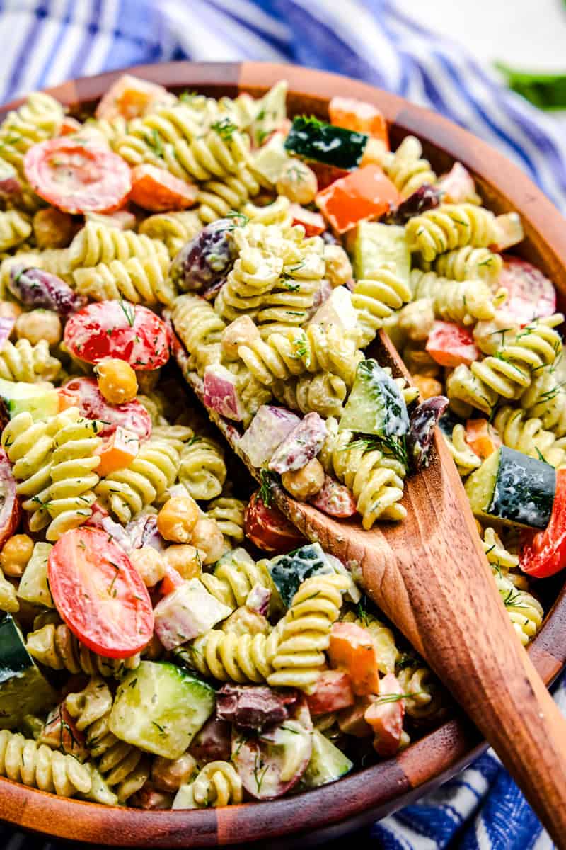 Whipped Feta Greek Pasta Salad in a large wooden serving bowl.