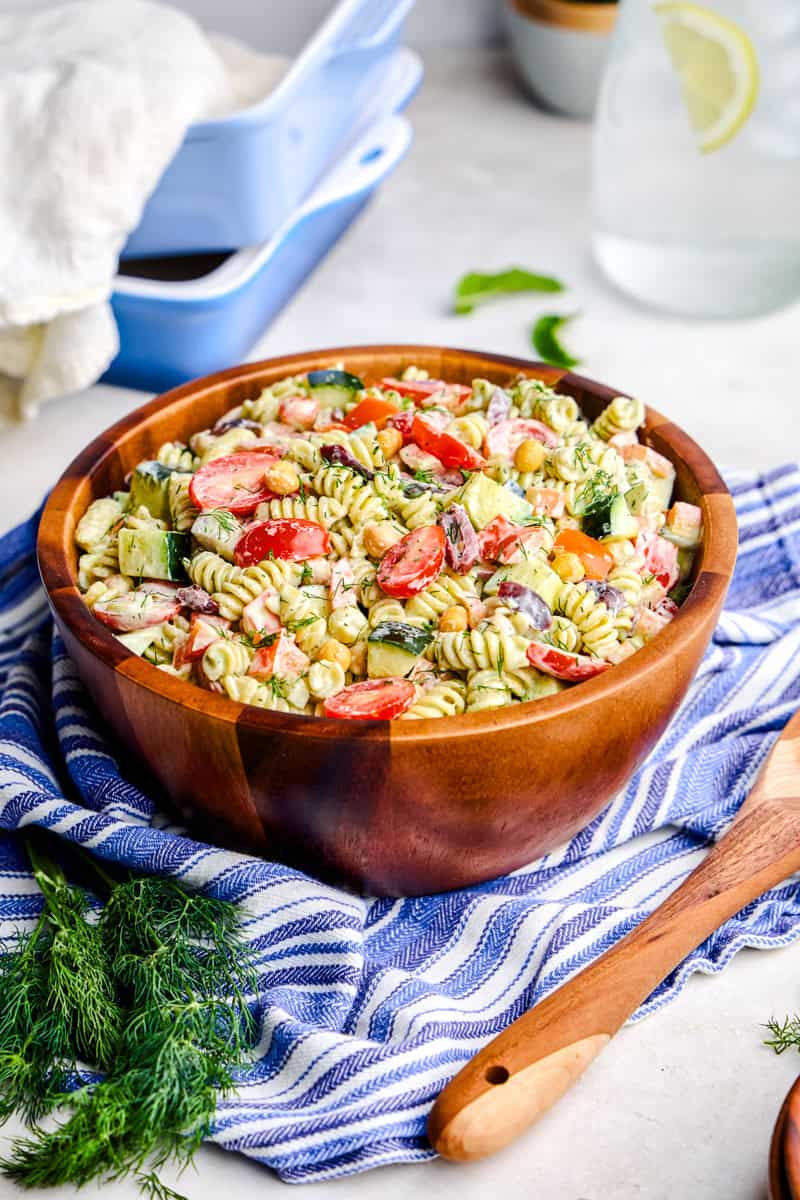 Whipped Feta Greek Pasta Salad in a large wooden serving bowl.
