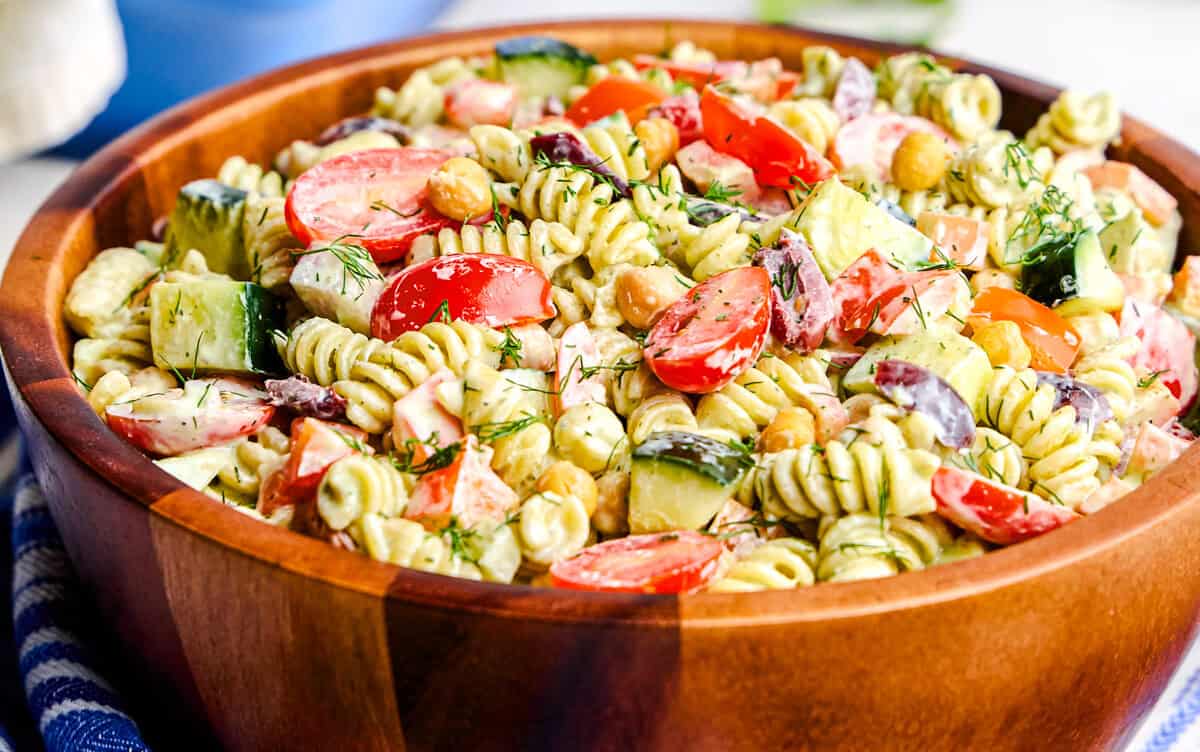 Whipped Feta Greek Pasta Salad in a large wooden serving bowl.