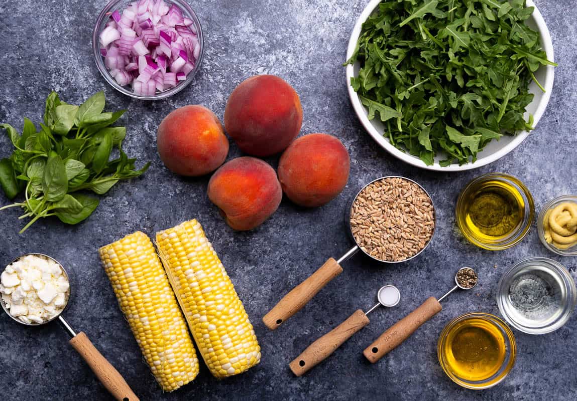 An overhead view of the ingredients needed to make peach farro salad.