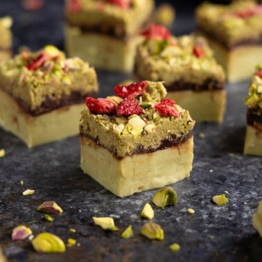 pieces of Dubai Chocolate Fudge with a pistachio base, chocolate ganache layer, and a kataifi topping/