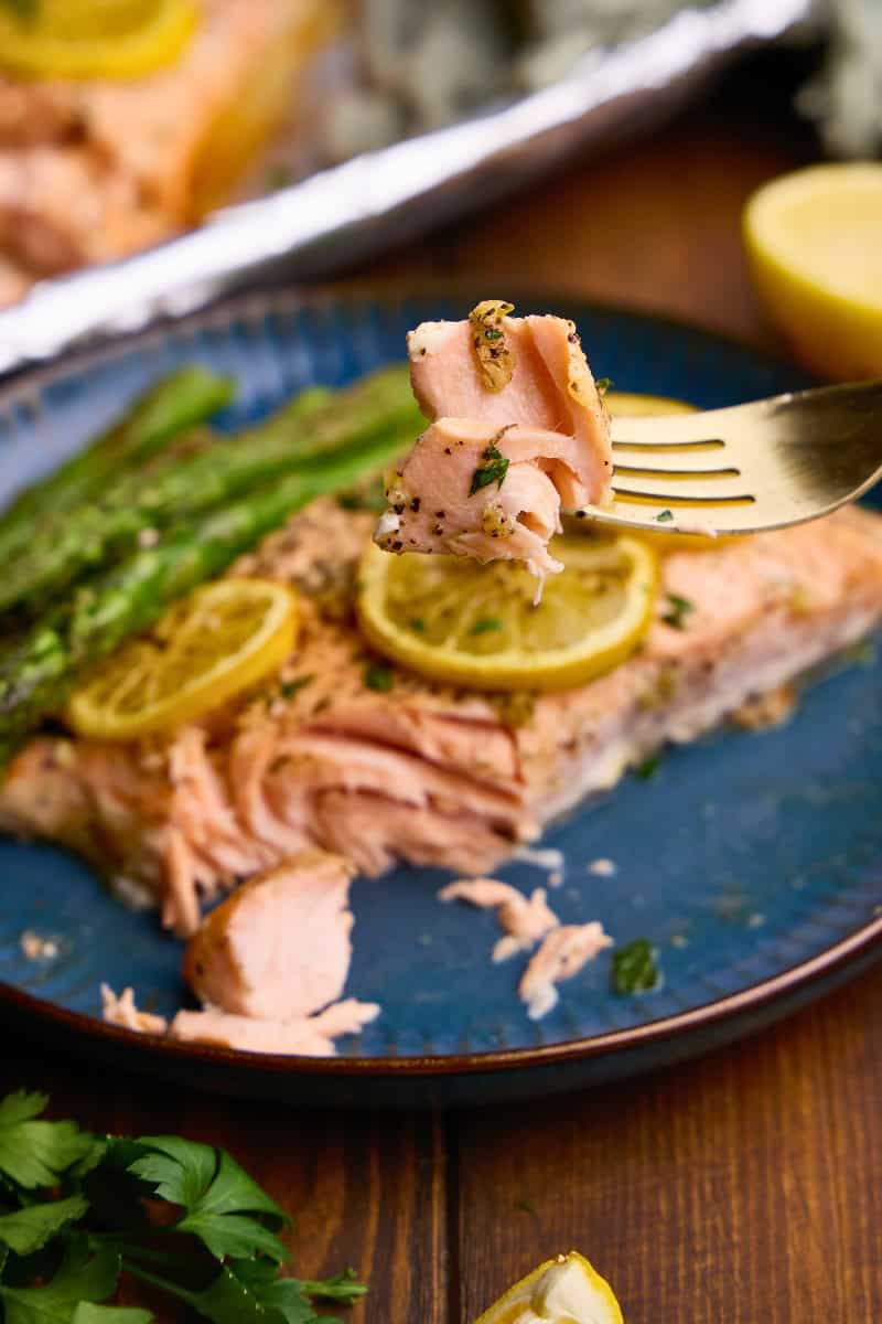 A bite of Easy Garlic Herb Baked Salmon on a fork.